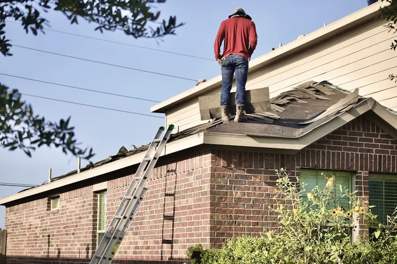 Professional roofer working on a residential roof in West Towson